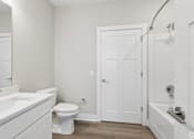 Thumbnail 63 of 71 - Bathroom with quartz countertops, closet, and bath/shower of an apartment unit.