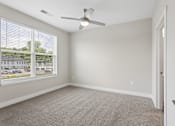 Thumbnail 68 of 71 - Carpeted bedroom with ceiling fan of a Tiffany Flats apartment home.