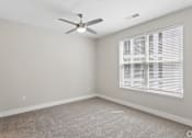 Thumbnail 56 of 71 - Carpeted bedroom with ceiling fan of a Tiffany Flats apartment home.