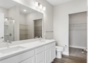Thumbnail 66 of 71 - Bathroom with quartz countertops, closet, and bath/shower of an apartment unit.