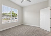 Thumbnail 53 of 71 - Carpeted bedroom with ceiling fan of a Tiffany Flats apartment home.