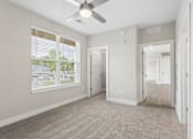 Thumbnail 60 of 71 - Carpeted bedroom and closet with ceiling fan of a Tiffany Flats apartment home.