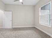 Thumbnail 57 of 71 - Carpeted bedroom with ceiling fan of a Tiffany Flats apartment home.