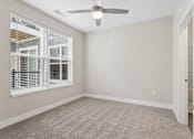 Thumbnail 55 of 71 - Carpeted bedroom with ceiling fan of a Tiffany Flats apartment home.