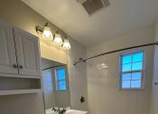 Thumbnail 8 of 21 - a bathroom with a toilet and a sink and a bath tub