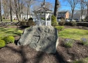 Thumbnail 7 of 7 - a large rock in a garden with a white gazebo