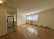 Thumbnail 2 of 12 - A room with wooden floors and a window with blinds.