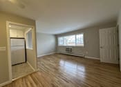 Thumbnail 8 of 9 - A room with wooden floors and a window with blinds.