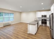 Thumbnail 5 of 32 - Kitchen with Gray Counters and Dining Area at The Point at Gateways, New Jersey, 07869