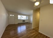 Thumbnail 3 of 12 - A room with wooden flooring and a window.