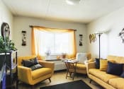 Thumbnail 9 of 13 - living room with model decor, large window, and wood-style flooring
