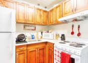 Thumbnail 6 of 13 - kitchen with white appliance package, and wood cabinetry