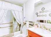 Thumbnail 7 of 13 - bathroom with sink vanity, toilet, and tub/shower with grab bars