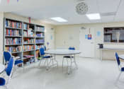 Thumbnail 5 of 12 - large library with tables and chairs set up for reading