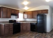 Thumbnail 8 of 13 - a kitchen with dark wood cabinets and black appliances