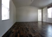 Thumbnail 11 of 13 - an empty living room with white walls and wood floors