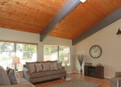 Thumbnail 4 of 18 - a living room with a wooden ceiling and a large window