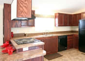 Thumbnail 14 of 18 - a kitchen with a black refrigerator freezer and a stove top oven