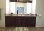 Thumbnail 11 of 18 - a bathroom with a sink and a mirror