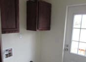 Thumbnail 12 of 18 - a kitchen with a door and cabinets on the wall