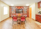 Thumbnail 11 of 22 - library with TV, shelves full of books, reading table, and coffee station
