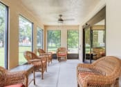 Thumbnail 13 of 22 - screened in patio with ceiling fan and tables and couches