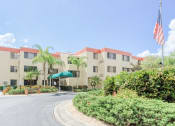 Thumbnail 4 of 22 - circular drive with lush landscaping in front of Villa San Carlos