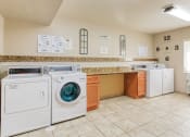 Thumbnail 14 of 22 - laundry center with washers and dryers and folding area