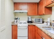 Thumbnail 17 of 22 - kitchen with pantry, appliances, stainless steel sink, and granite countertops