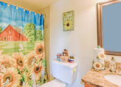 Thumbnail 22 of 22 - bathroom with toilet, granite vanity, and shower with colorful shower curtain