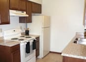 Thumbnail 11 of 18 - Modern Kitchen With Stainless Steel Appliances And Double Door Refrigerators at Parkside Manor, Coralville, IA