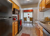 Thumbnail 10 of 18 - Fully Equipped Eat-In Kitchen at The Apartments at The Sycamores, Reston, VA, 20190