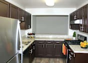 Thumbnail 11 of 25 - Kitchen with wooden closet at The Apartments at Wellington Trace, Maryland