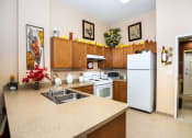 Thumbnail 4 of 12 - entrance way into kitchen with appliances, cabinetry, and tile flooring
