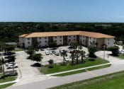 Thumbnail 11 of 12 - St. John XXIII Villas with large parking lot and palm trees