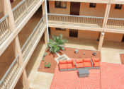 Thumbnail 20 of 24 - balconies looking into courtyard patio with swings and plants