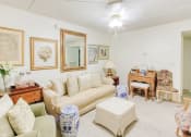 Thumbnail 14 of 24 - living room with ceiling fan, plush carpet and model furniture