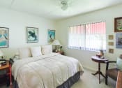 Thumbnail 15 of 24 - bedroom with ceiling fan, window, berber carpet, and model furnishings