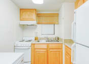 Thumbnail 12 of 24 - kitchen with white appliances, double stainless steel sink, and wood cabinetry