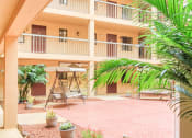 Thumbnail 22 of 24 - patio with relaxing swings, palms, and potted plants