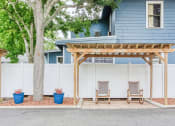 Thumbnail 24 of 24 - pergola with chairs beside fence with potted plants and large tree
