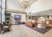 Thumbnail 1 of 30 - spacious lobby with chandelier, lots of seating, and massive windows
