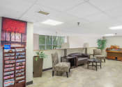Thumbnail 16 of 30 - sitting area with magazine rack, couch and chairs, and piano