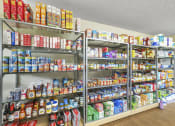 Thumbnail 17 of 30 - Resident store with shelves of canned and dry goods
