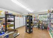 Thumbnail 18 of 30 - resident store with shelves of canned and dry goods and fridges with fresh and frozen food