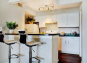 Thumbnail 6 of 19 - Kitchen and seating at breakfast bar