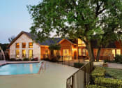 Thumbnail 6 of 25 - pool and exterior clubhouse at sunset