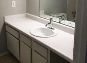 Thumbnail 5 of 8 - Bathroom sink and mirror at Landmark Apartment Homes, Meridian, Mississippi