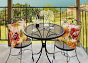 Thumbnail 31 of 33 - Patio with table and two chairs at Sugar Tree Apartment Homes, Corpus Christi, Texas