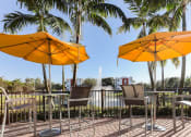 Thumbnail 8 of 30 - shaded outdoor seating overlooking lake